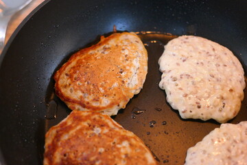 pancakes in a pan. Frying Pan On The Stove. Pancake Burned On The Pan. Mans Hand Turns The Pancake To The Other Side. He Lingers When He Sees That The Pancake Has Burned.
