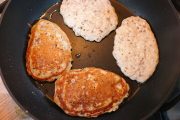 pancakes in a pan. Frying Pan On The Stove. Pancake Burned On The Pan. Mans Hand Turns The Pancake To The Other Side. He Lingers When He Sees That The Pancake Has Burned.