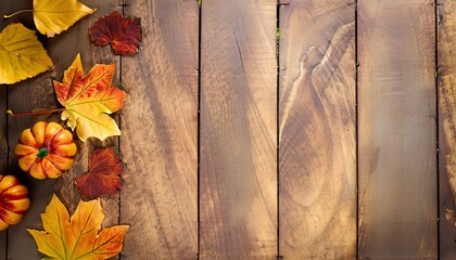 Wooden table decorated with Autumn Leaves and Maple Leaves and Pumpkins with Space for Copy and Background
