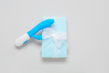 Gift box and vibrator on white background