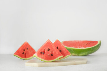 Pieces of ripe watermelon on light background