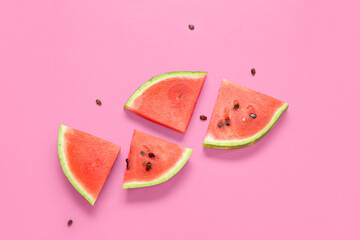 Composition with pieces of ripe watermelon on pink background