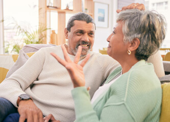 Love, mature couple and talk on sofa in home for happy chat, care and conversation together with marriage partner. Man, woman and speaking on couch in support, loyalty or communication in living room