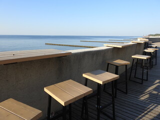 an empty cafe on the seashore at the hot day
