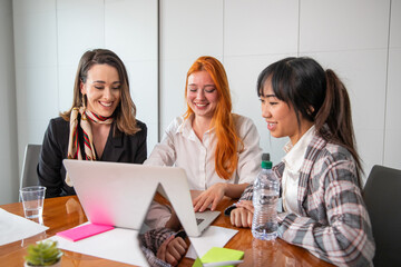 Three business women working on project in office, multi ethnic environment and happy coworkers