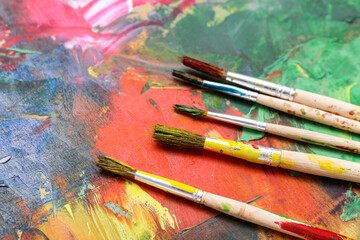 Artist's brushes on paint palette, closeup