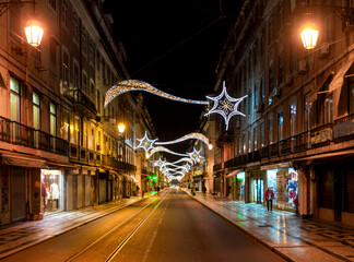 Night shot of a Lisbon street at Christmas with lights and illuminations, Portugal.