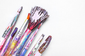Fototapeta premium Dirty paint brushes on white background
