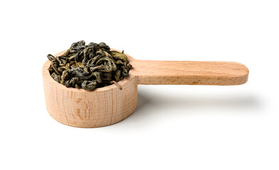 Wooden spoon with dry green tea leaves on white background