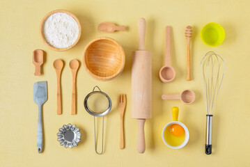 Fototapeta na wymiar Set of baking utensils and ingredients on beige background