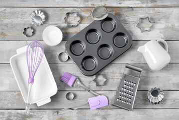 Set of kitchen utensils and baking dish on wooden table