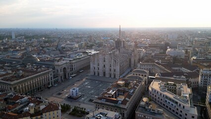 Europe, Italy, Milan - Aerial view of Piazza Duomo, gothic Cathedral in downtown center city. Drone aerial view of the gallery and rooftops during sunrise - Duomo Unesco Heritage sightseeing 