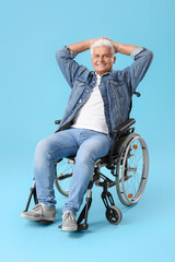 Obraz premium Mature man in wheelchair on blue background