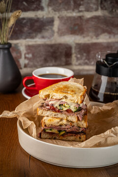 American cuisine concept. Double sandwich with roast beef, bell peppers and pickled cucumbers. background image