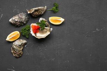 Tasty oysters with lemon and red caviar on black background