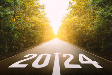 The new year 2024 or straightforward concept. Text 2024 written on the road in the middle of...