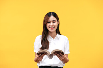 Young asian woman wearing white short sleeve shirt and holds holy bible to reading and praying to...