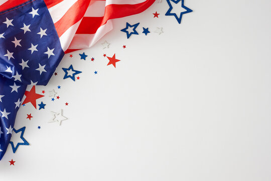 Building a concept around the celebration of Labor Day. Top view composition of american flag, patriotic stars on white background with empty space for advert or message