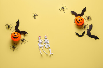 Composition with skeletons, paper bats, pumpkins and spiders for Halloween celebration on beige background