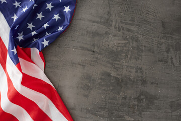 Obraz premium Crafting a vision for a celebratory Labor Day concept. Top view photo of USA national flag on concrete gray background with empty space for promo or text