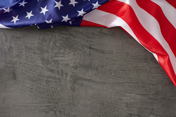 Embracing the idea of a festive Labor Day celebration.Top view shot of american national flag on concrete gray background with empty space for promo or message