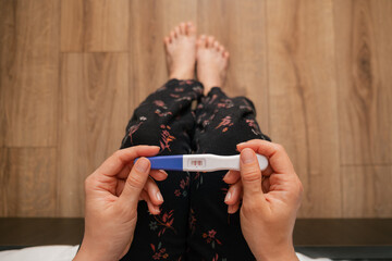positive pregnancy test in woman hand close up