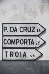 Obraz premium Road signs in Melides, Alentejo, directing the way to Pinheiro da Cruz, Comporta, and Troia.