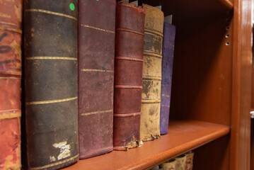 Old books from the old Viblioteca on wooden shelves, with various smells, old leaves and old leather pastes