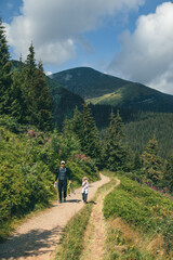 Fototapeta premium father with daughter at mountain trail