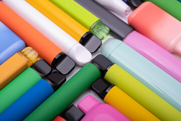Synthetic nicotine concept. Various disposable electronic cigarettes. modern alternative smoking, vaping and nicotine. Close up