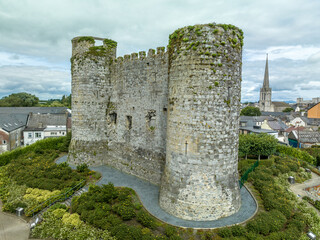 Fototapeta na wymiar Aerial view of Carlow castle and town in Ireland with circular towers above the river Barrow