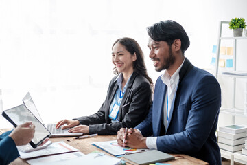 Colleagues meeting discuss business project planning, marketing strategies, and financial report analysis for business investment planning.