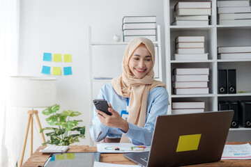 Businesswoman Wearing Hijab Works on Laptop, Does Data Analysis.