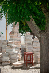 Melides, Alentejo, Portugal. June 18 of 2023. Sculpted marble books stacked artfully, a unique masterpiece gracing Melides village center. A blend of literature and craftsmanship