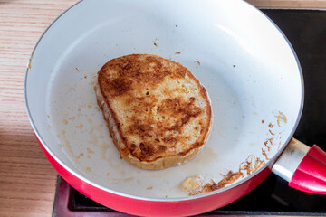making delicious Fried bread slices on a pan. Close up