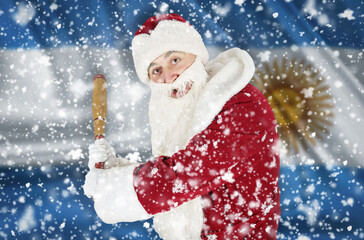 Santa Claus aggressively threatens with a bat against the backdrop of falling snow and the flag of Argentina