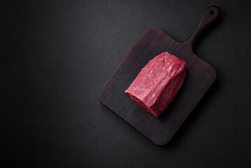 Juicy fresh raw beef meat with salt, spices and herbs
