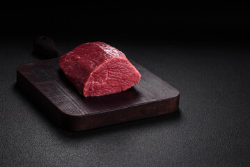 Juicy fresh raw beef meat with salt, spices and herbs