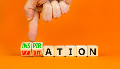 Inspiration or mobilization symbol. Concept words Inspiration and Mobilization on wooden cubes. Beautiful orange background. Psychologist hand. Psychology inspiration mobilization concept. Copy space.