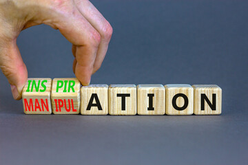 Inspiration or manipulation symbol. Concept words Inspiration and Manipulation on wooden cubes. Beautiful grey background. Psychologist hand. Psychology inspiration manipulation concept. Copy space.