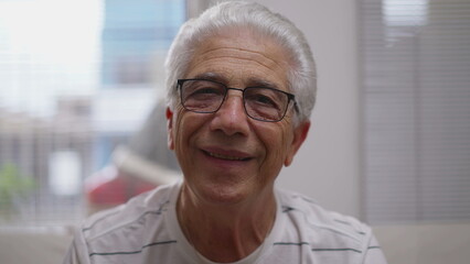 Headshot portrait of Elderly man nodding yes to camera smiling. affirming conversation, close-up...