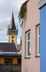 Modern buildings in the historic center of the city next to the baroque castle tower