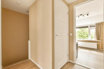an empty room with wood flooring and white sliding doors in the door is open, there is a window that looks out to