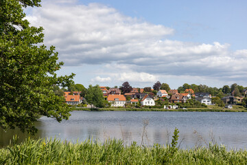 Obraz premium Happy wanderlust in Borgvold park in Viborg. Borgvold at Nørresø is located in a place where there was a place of violence in the High Middle Ages,Viborg,Denmark