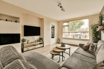 a living room with two couches and a flat screen tv on the wall in the room is very clean