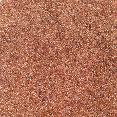 Orange focused glitter texture as background