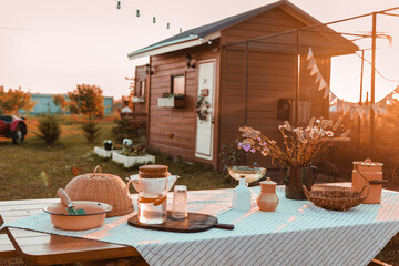 A covered wooden table in the courtyard of a country house. Country life, life in the country.