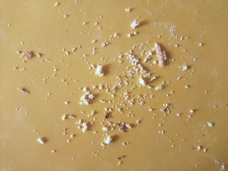 Bread crumbs on a yellow background in close-up.
