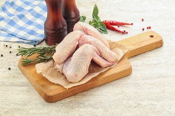 Raw chicken wings over board