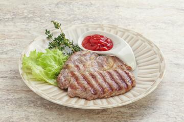 Grilled pork neck steak with ketchup